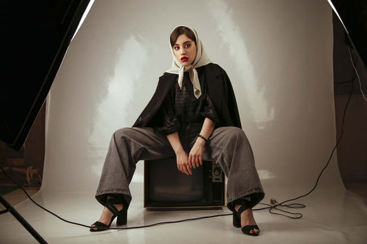 woman in retro pant outfit looking at camera