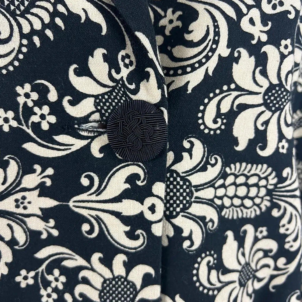 Fabric Detail View of the Andiamo Midi Black and Cream Brocade Coat