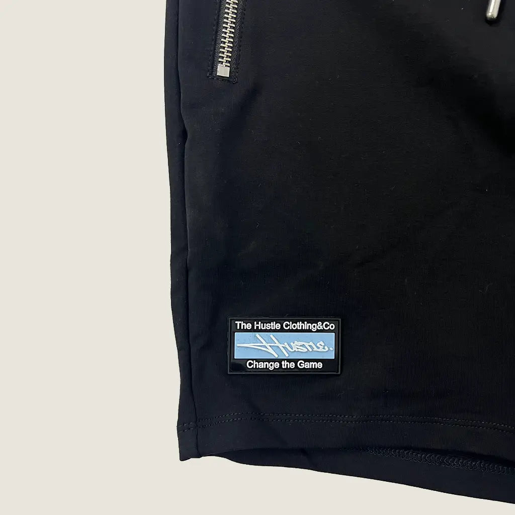 Front Hem Detail View of the The Hustle Clothing & Co. Black Script Logo Shorts