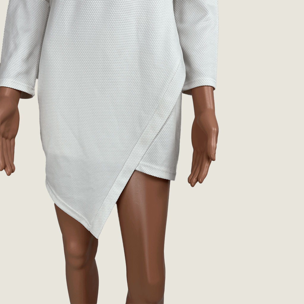 Front view of hem of the Levantine White Cut Out Midi Dress