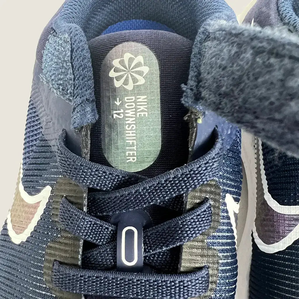 Front Lace Detail View of the Nike Downshifter 12 Next Nature GS Kids Running Shoes