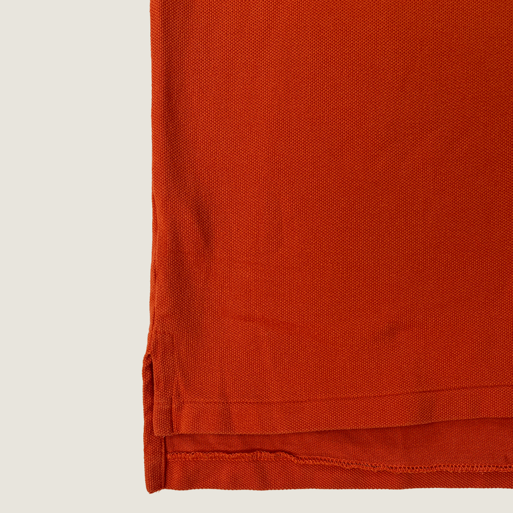 Front hem detail of the orange Ralph Lauren Short Sleeve Men's Polo