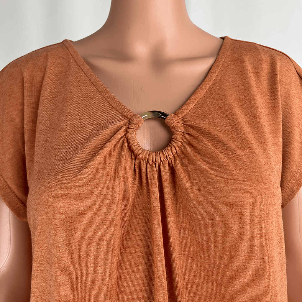 V neckline detail of the Suzannegrae tunic midi dress