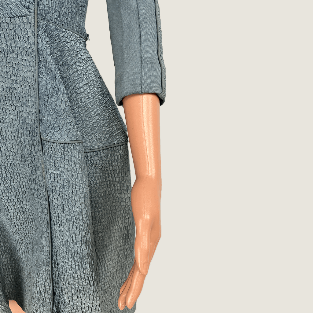 Front close up view of the asymmetric hips on the Willow blue grey cut out evening dress