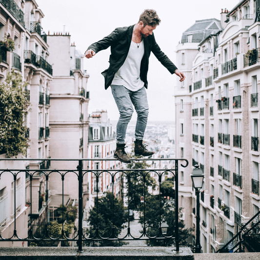 Man standing on rail