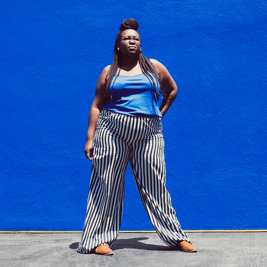 Woman standing in front of Blue wall