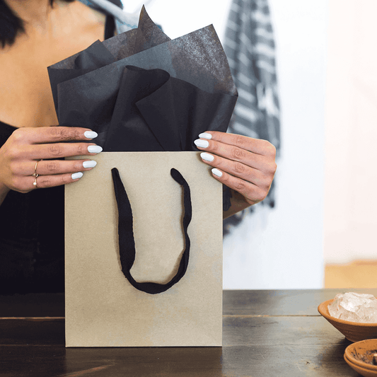 woman hands closing paper bag