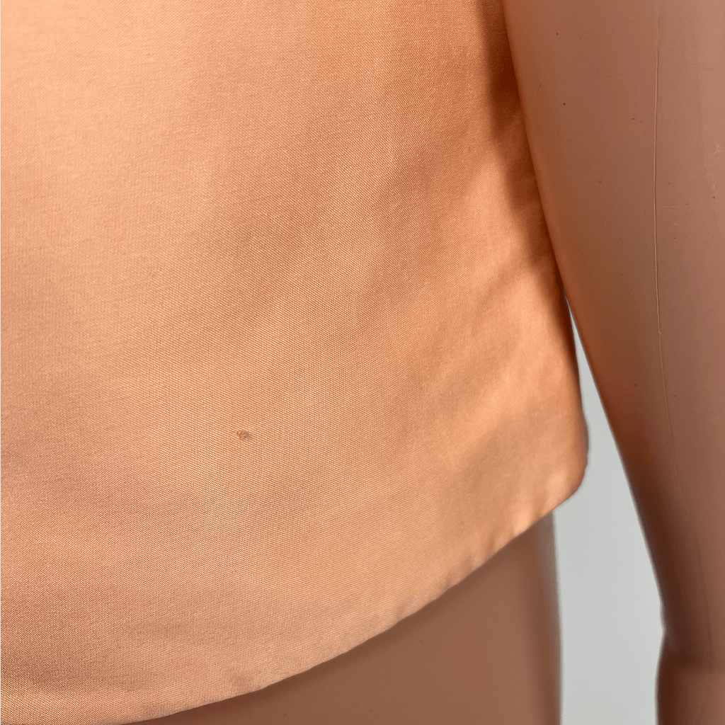 Close up of hem on a August Street short sleeve top- small fabric imperfection shown