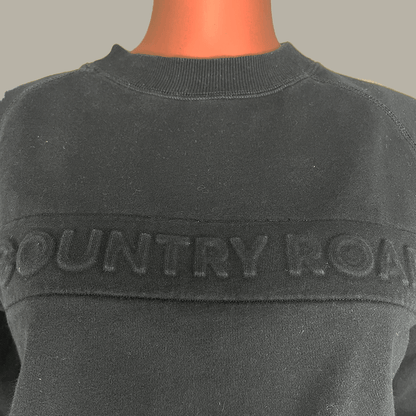 Detail view of the logo on the Country Road Heritage Black Sweat