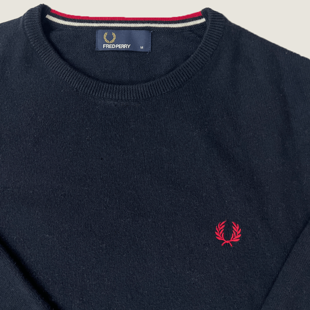 Front collar detail of the Fred Perry black classic knit top