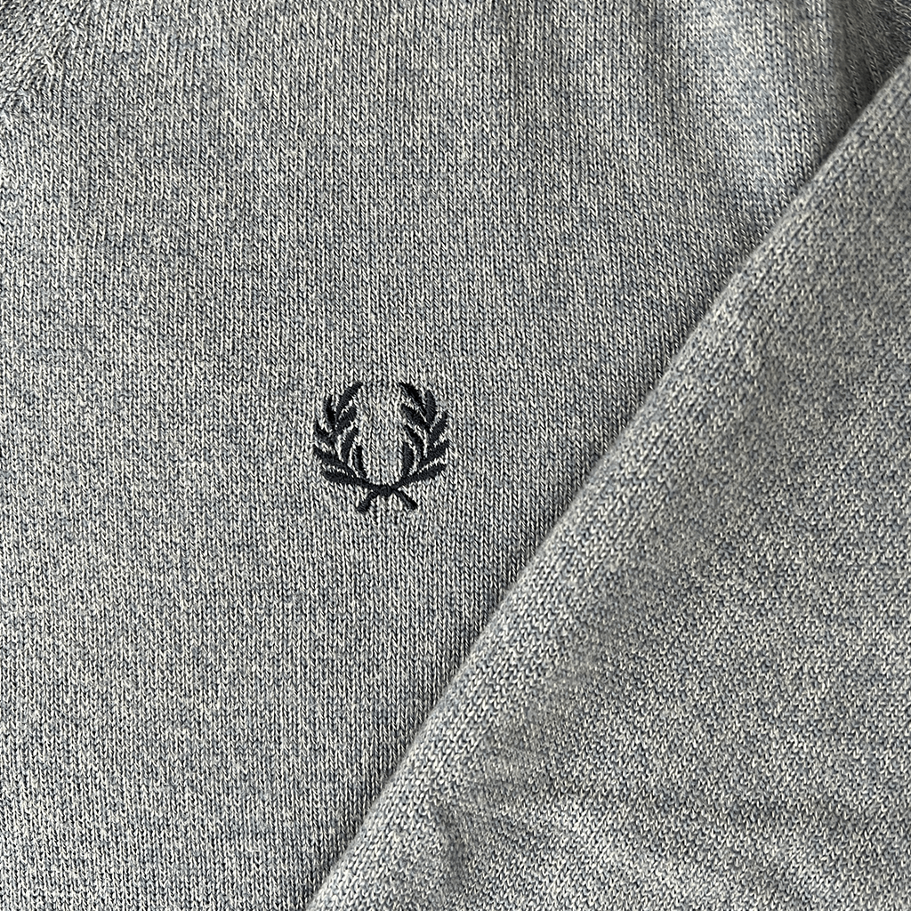 Front detail view of the Fred Perry Knit Tennis V-Neck Jumper Logo at the front