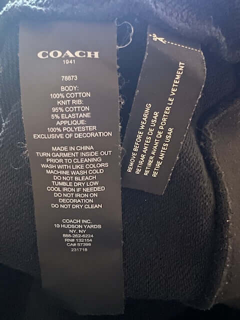 Tag detail of the Coach Rexy the Dinosaur Black Hoodie