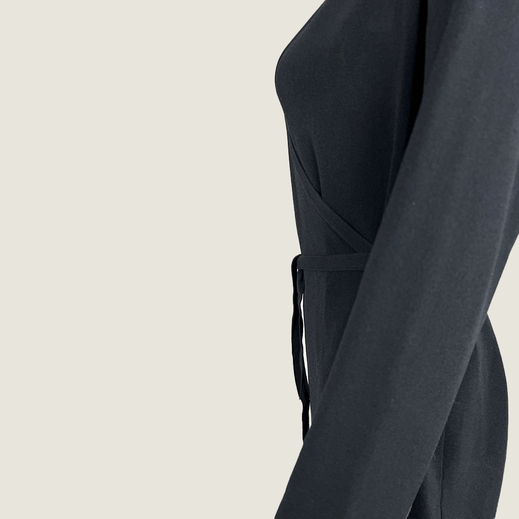 Side Detail View of the Legoe Black Knit Wrap Midi Dress