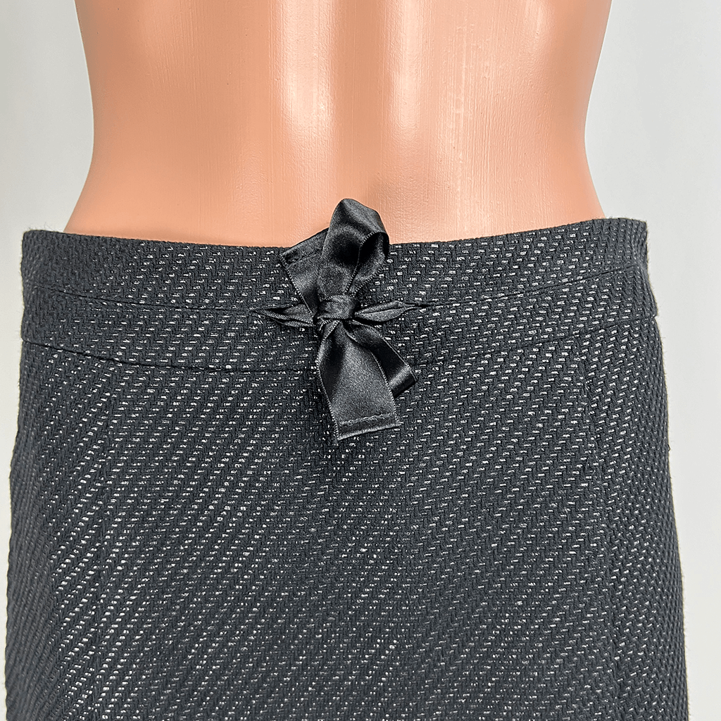 Front close up view of the waist and bow on the Max & Co. black mini skirt