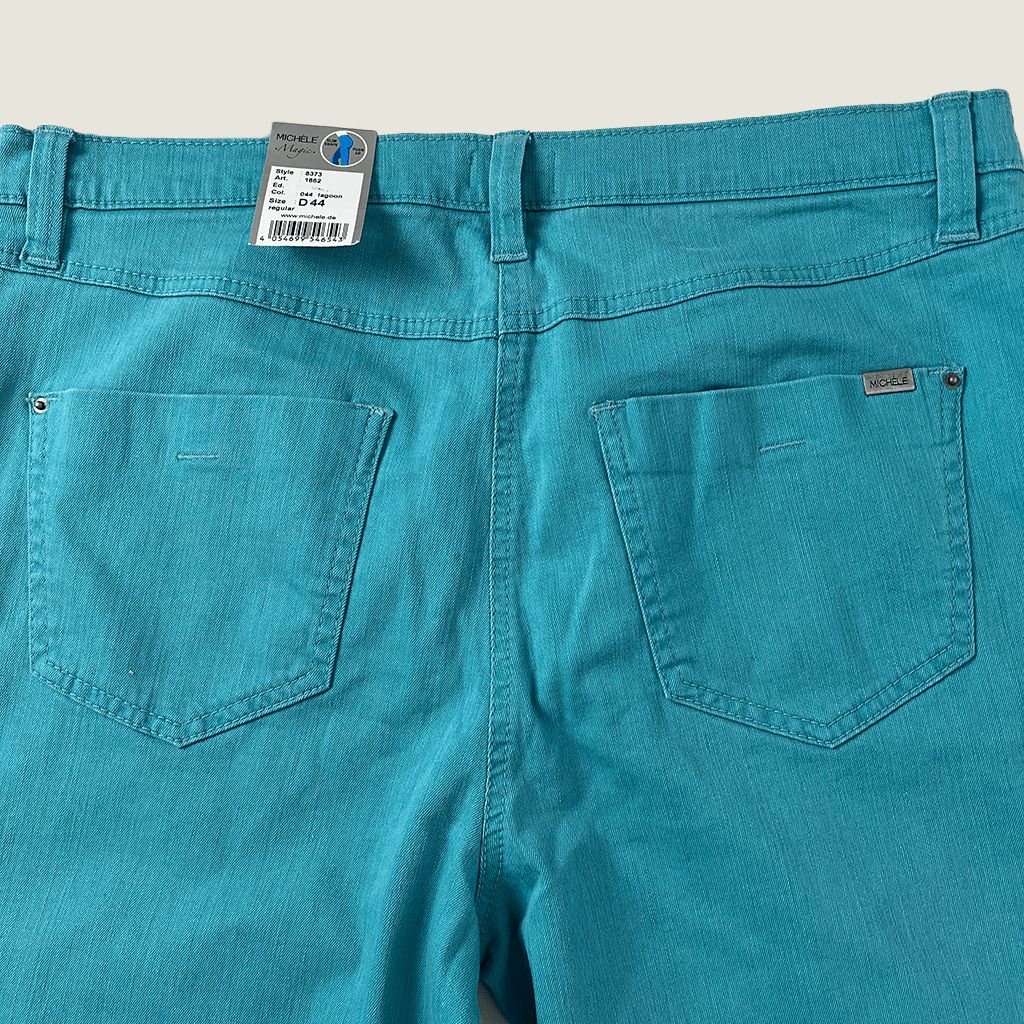 Front close up view of the waist of the Michele Magic aqua jeans