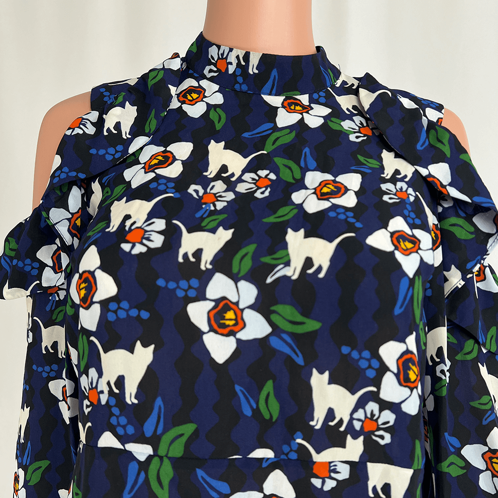 Collar detail of cat and flower print Topshop long sleeve blouse with cut out at shoulder