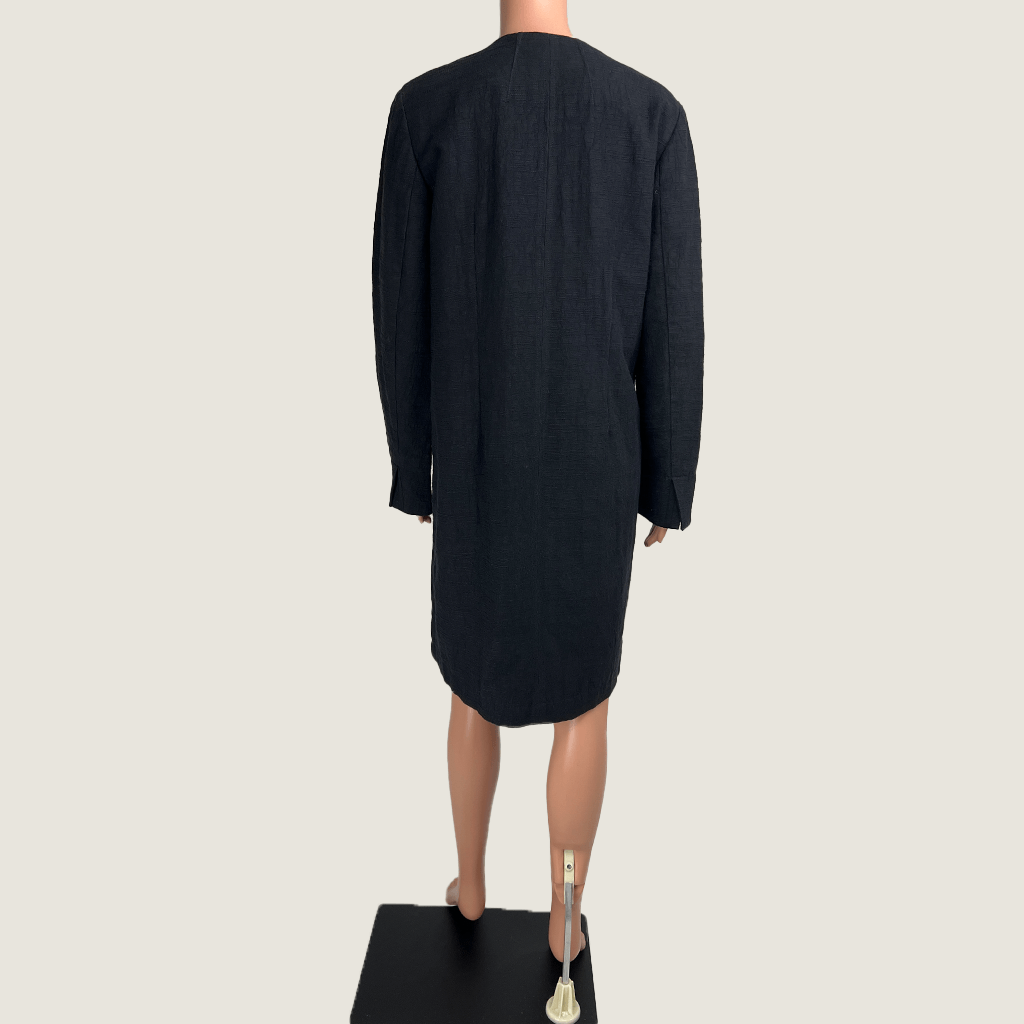 Back view of the Verge black collarless overcoat