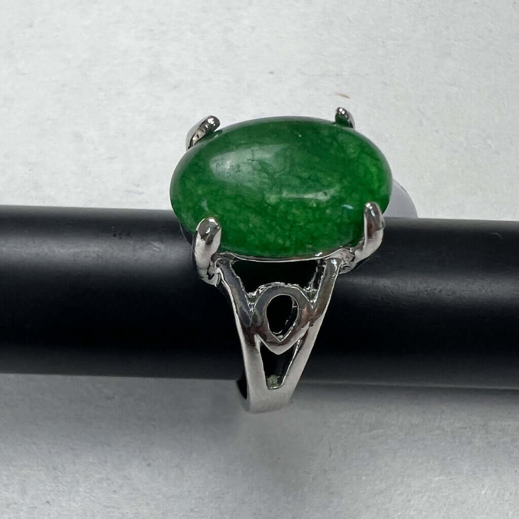 Silver Rings With Bright Green Stones Above 