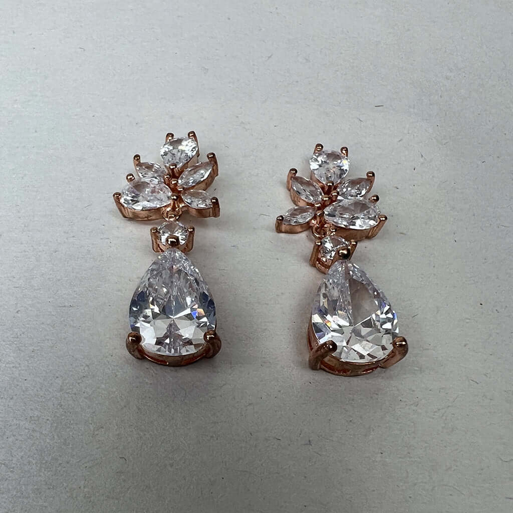 Rose gold drop earrings pair low angle