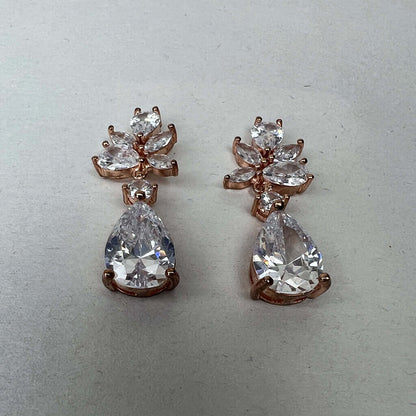 Rose gold drop earrings pair low angle