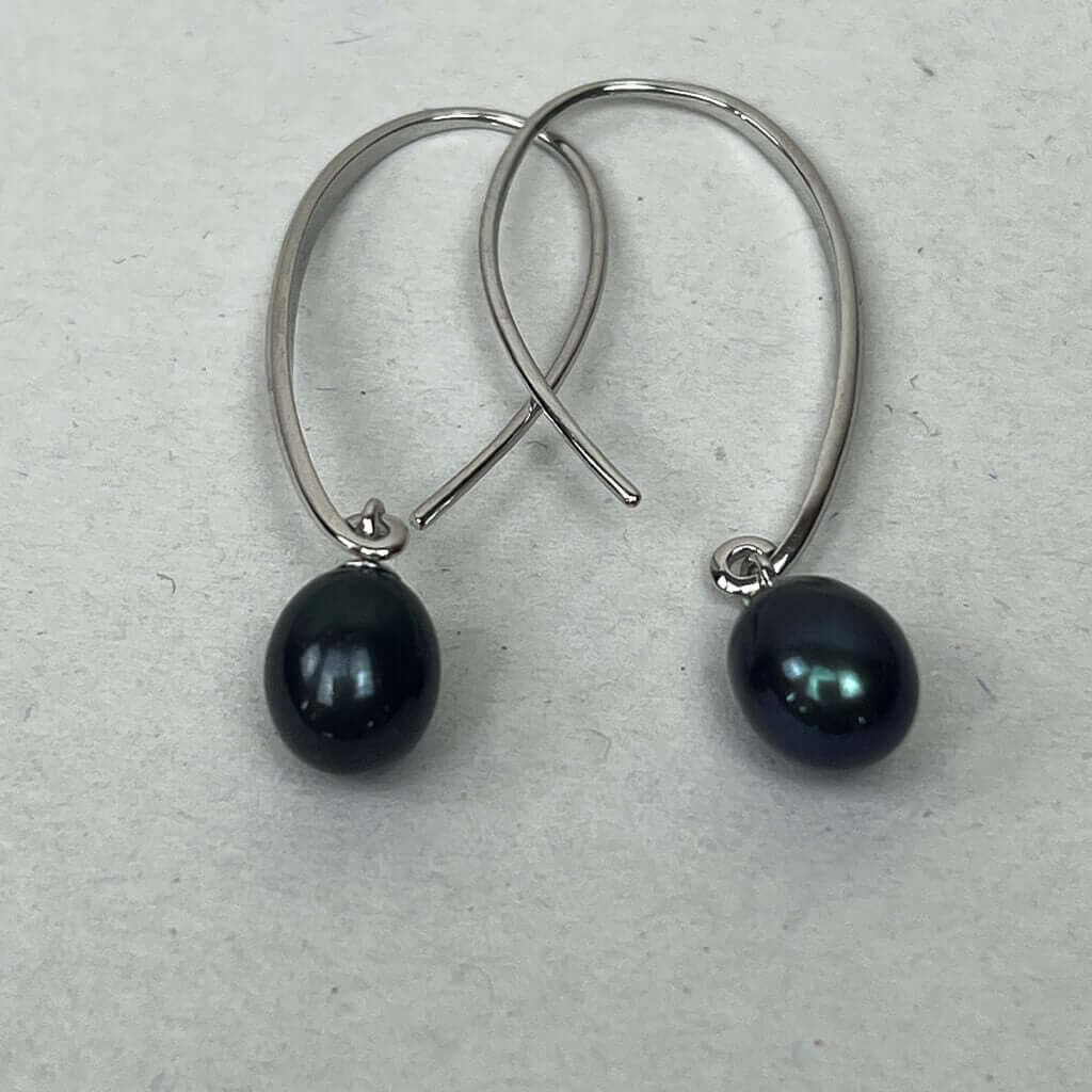 black pearl drop earrings on white