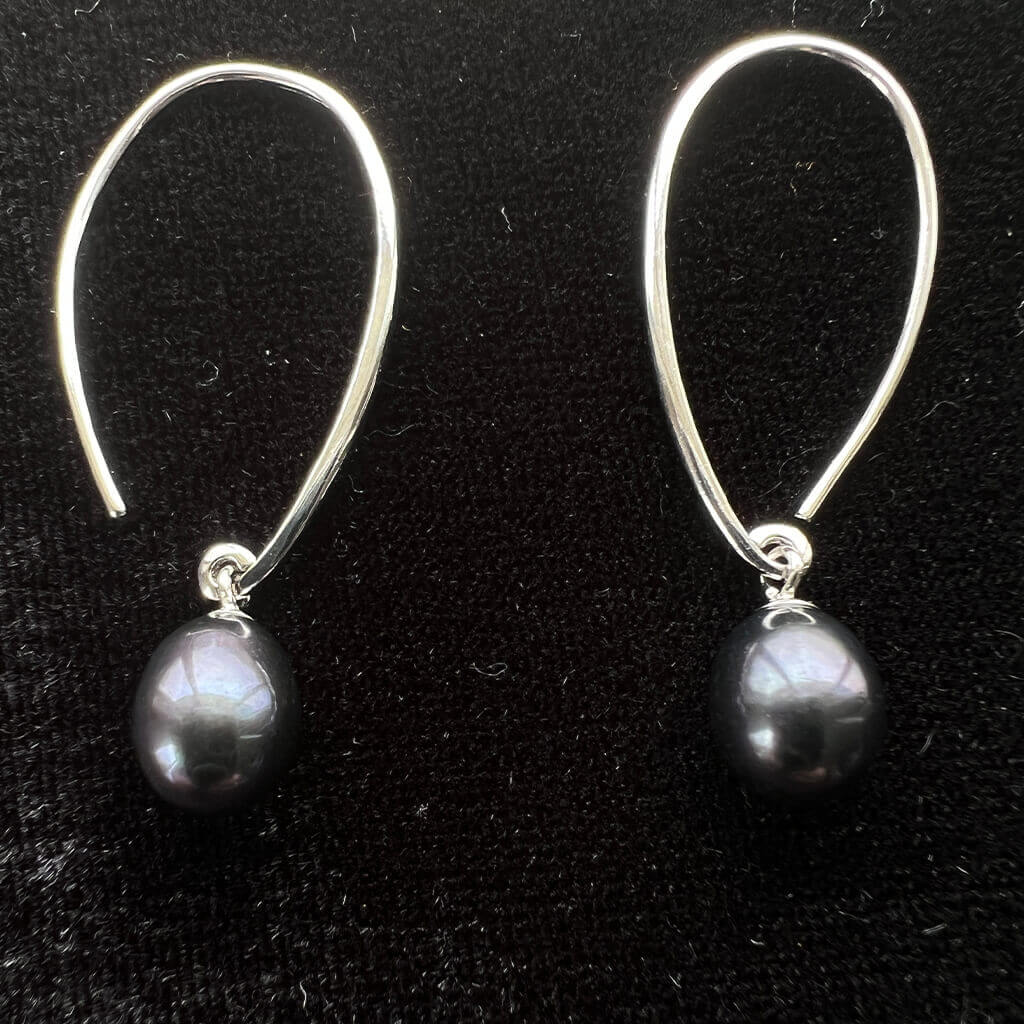 black pearl drop earrings on black